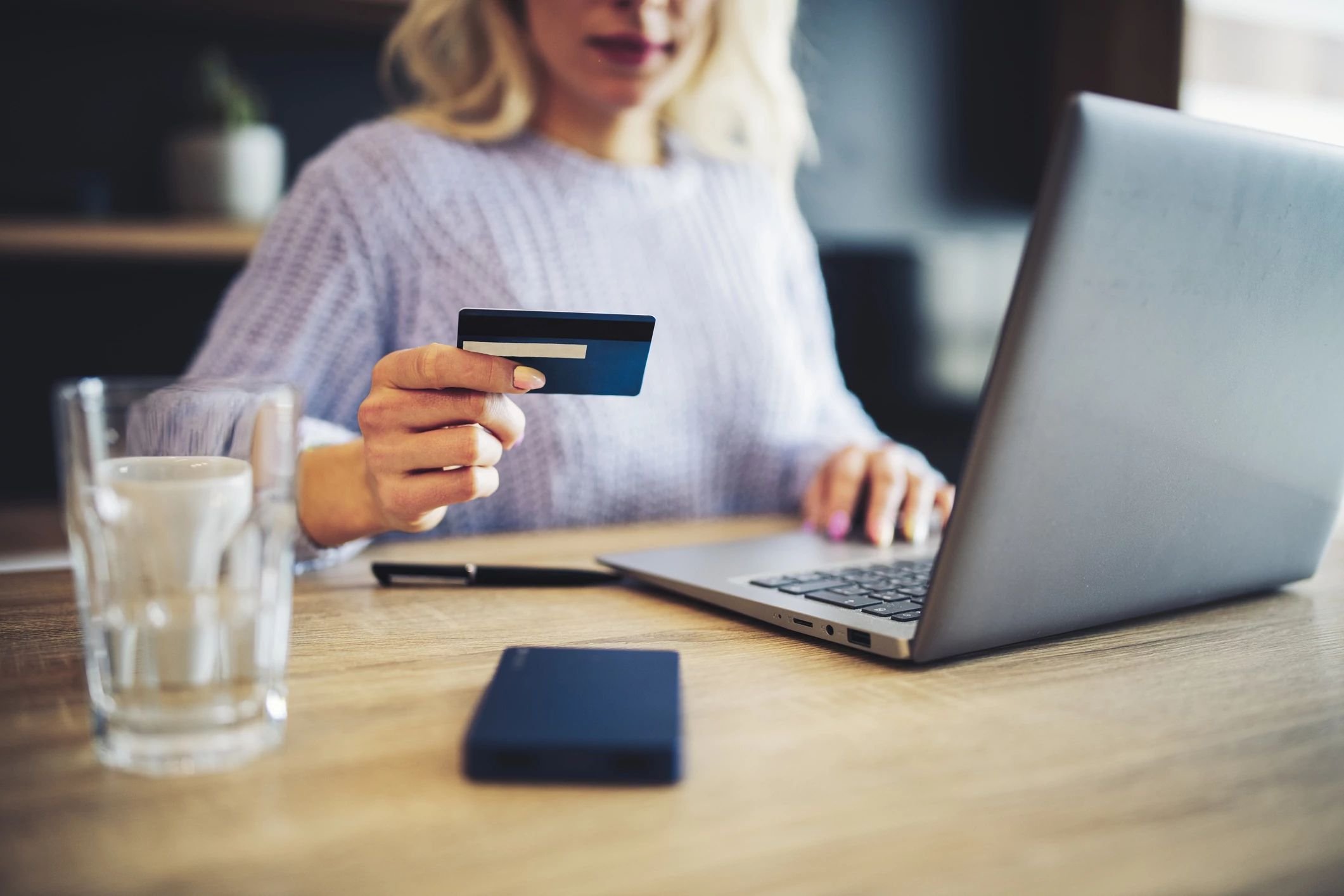 Person using a laptop to pay online by card - Fast and easy financing with approved credit via Wells Fargo from Brosious Carpet and Floors Inc in Missoula, MT