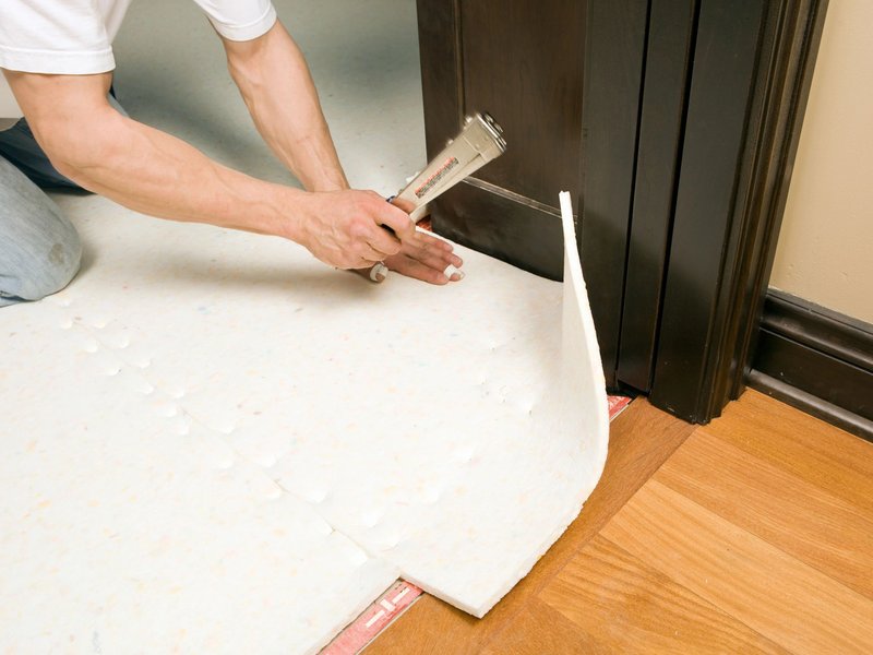 Person installing flooring Underlayment from Brosious Carpet and Floors Inc in Missoula, MT