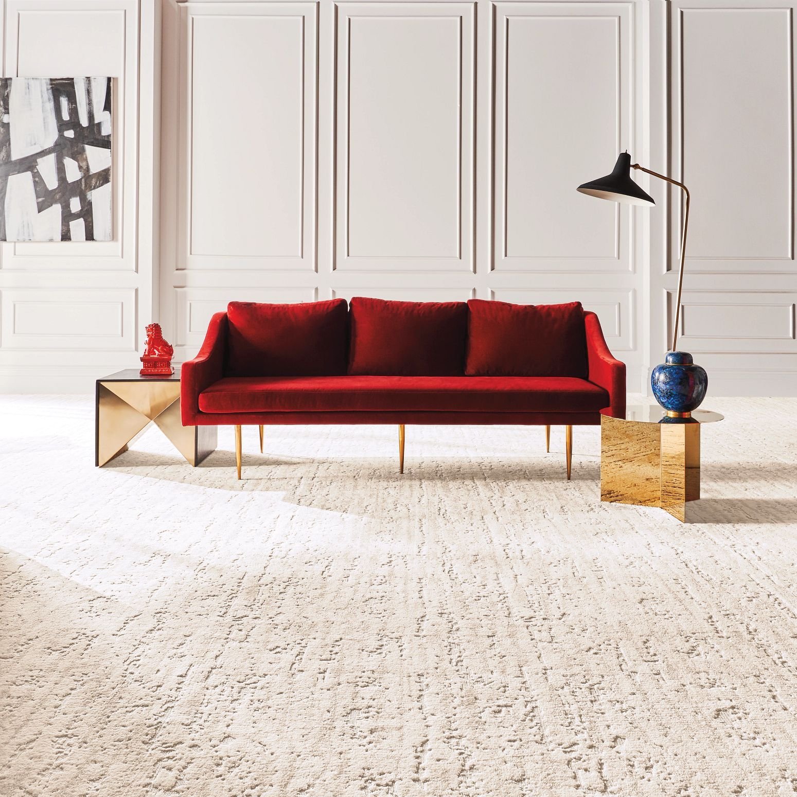 Bright living room with a red velvet couch and beige textured carpet from Brosious Carpet and Floors Inc in Missoula, MT