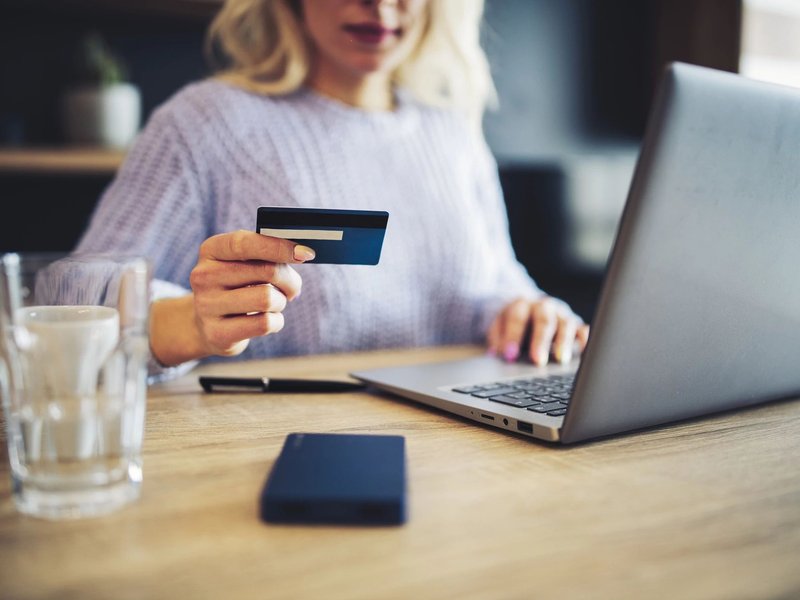 Person using a laptop to pay online by card - Fast and easy financing with approved credit via Wells Fargo from Brosious Carpet and Floors Inc in Missoula, MT