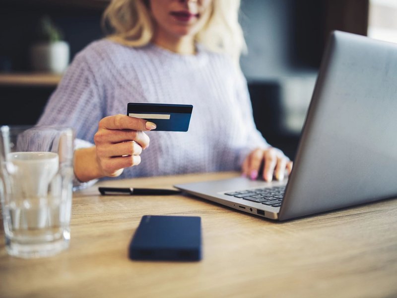 Person using a laptop to pay online by card - Fast and easy financing with approved credit via Wells Fargo from Brosious Carpet and Floors Inc in Missoula, MT